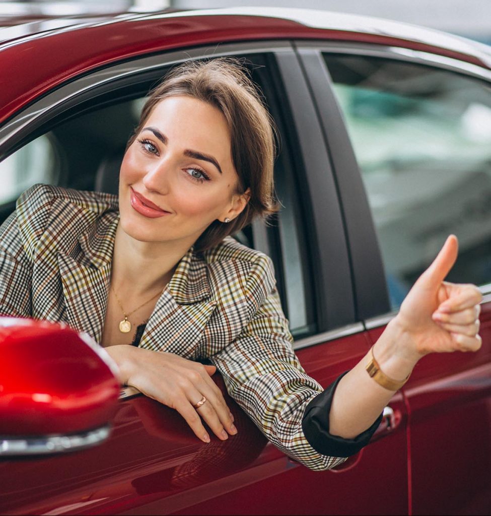 Woman sitting i car in a car showrrom